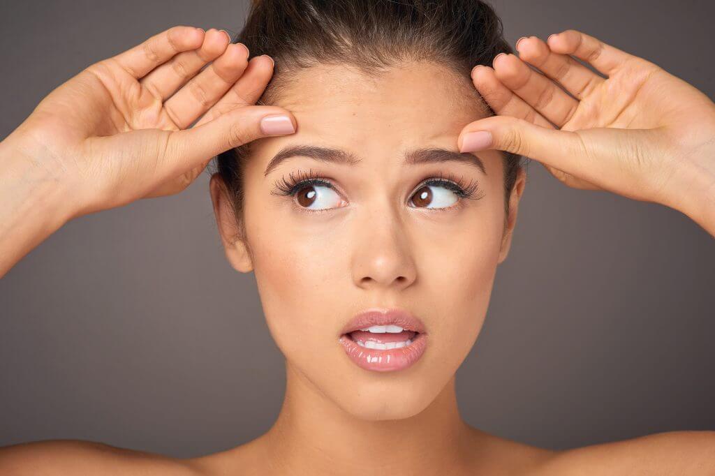 Person worried about sun damage and skin aging