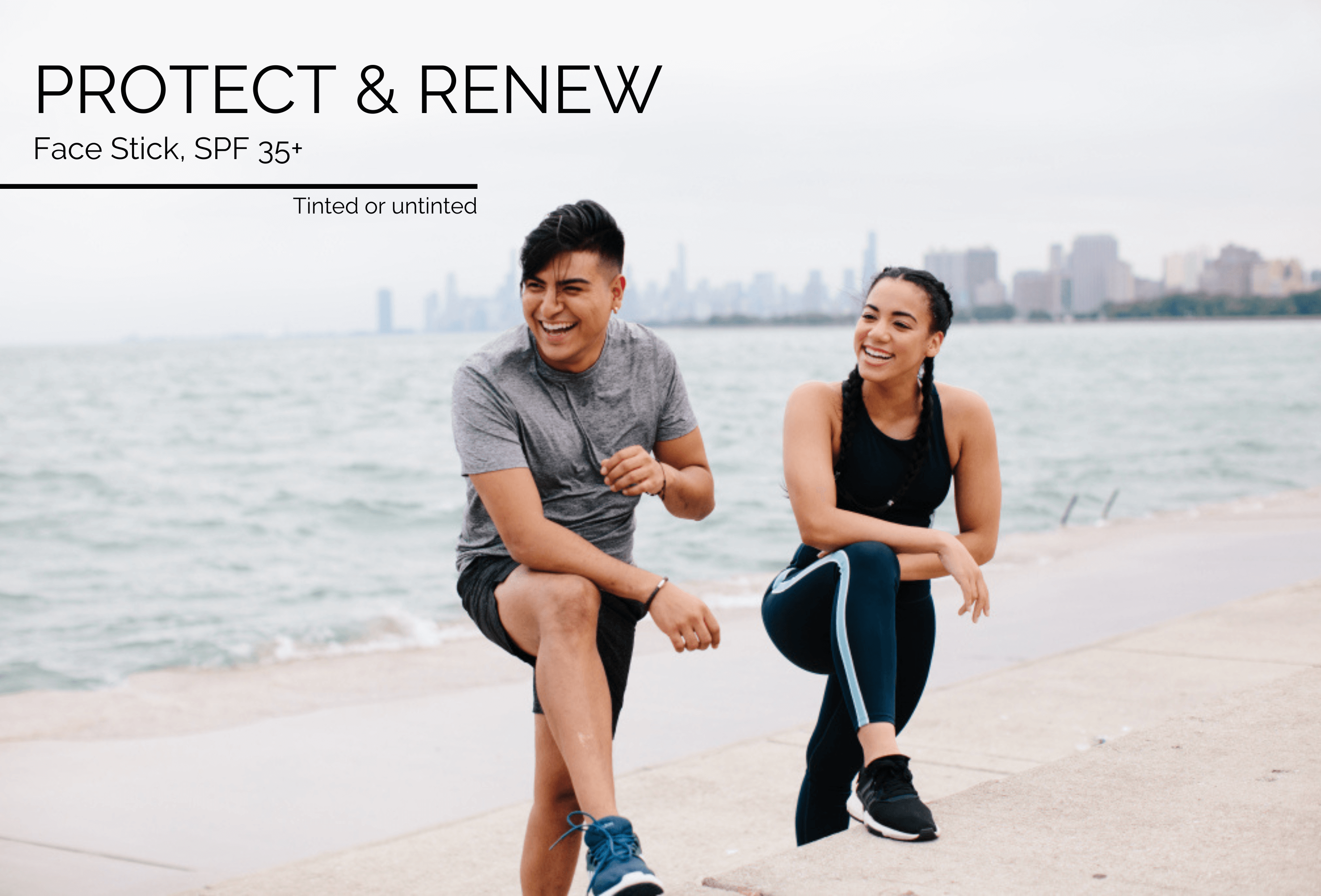 Man and woman in workout attire laughing and stretching in front of the Chicago skyline