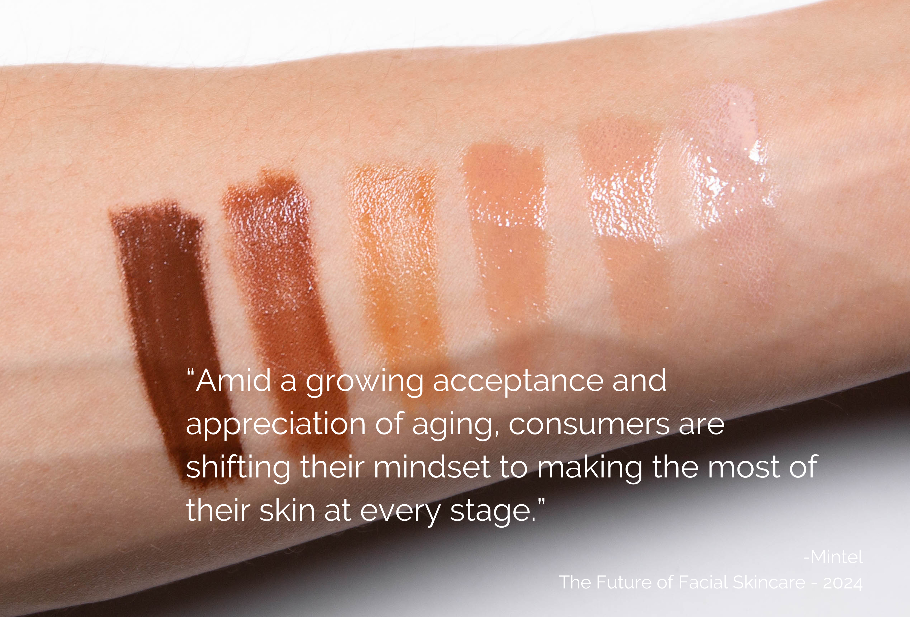 Woman wearing a pink satin robe doing her skincare routine