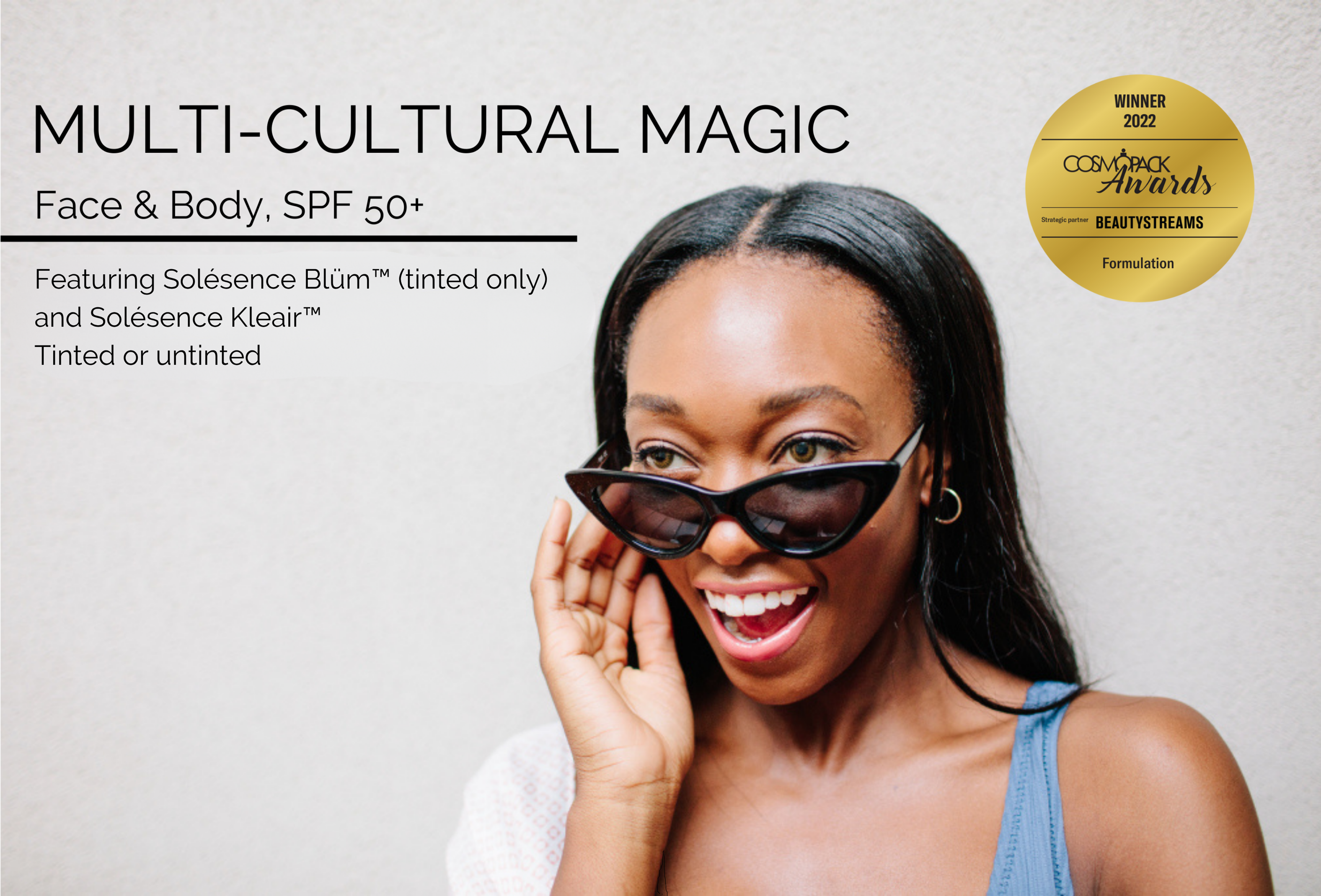 A woman wearing black sunglasses, laughing