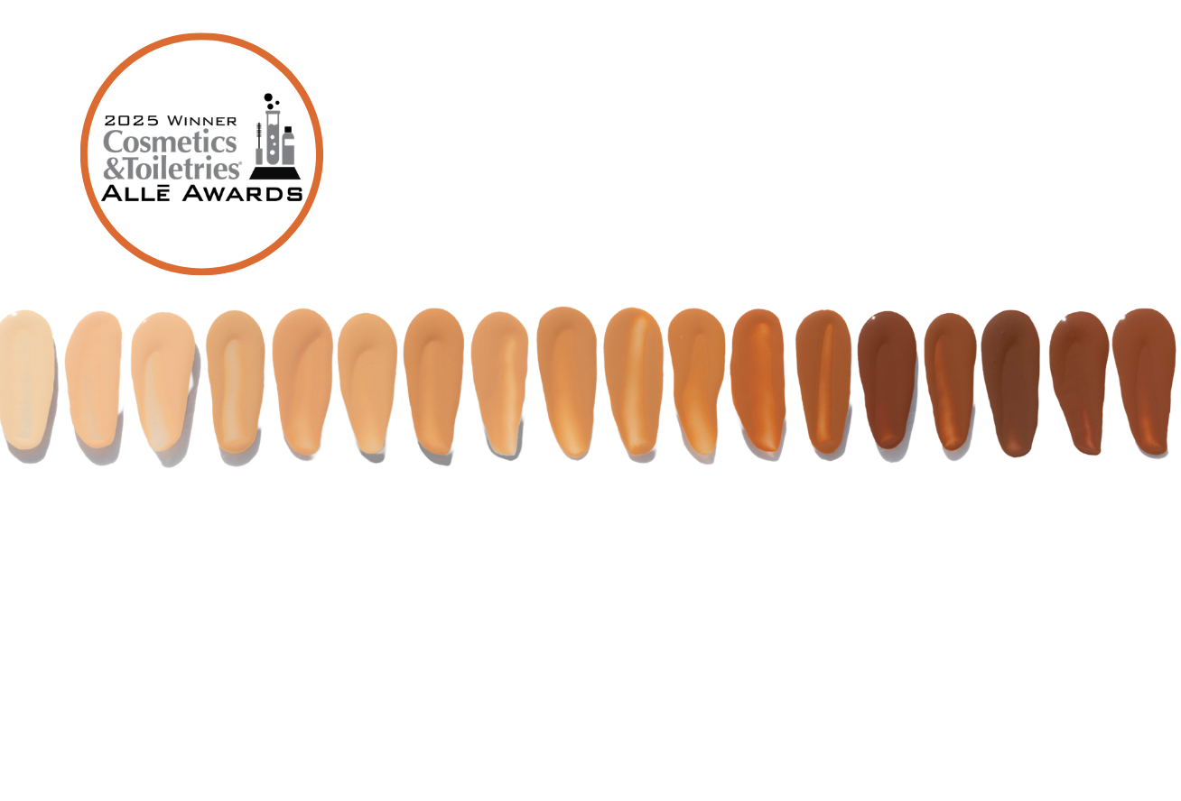 A bottle of makeup with two dots of makeup next to it