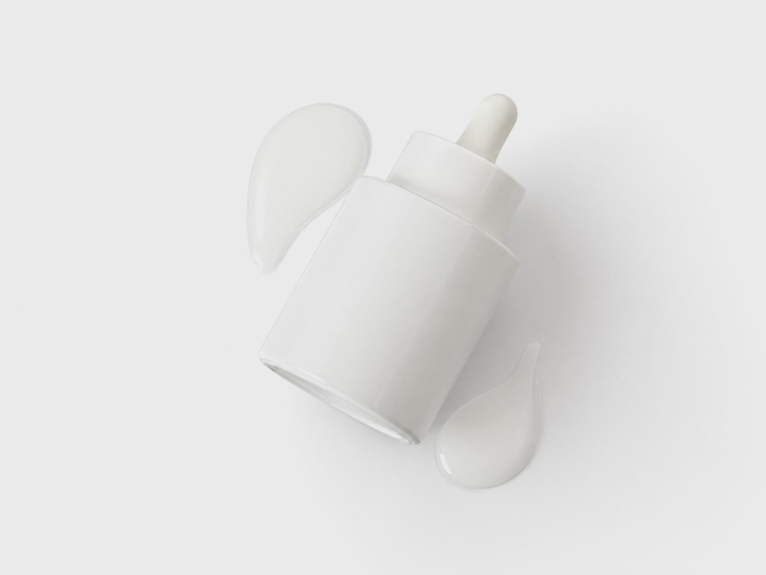 Swipes of serum on a white background next to a small jug.